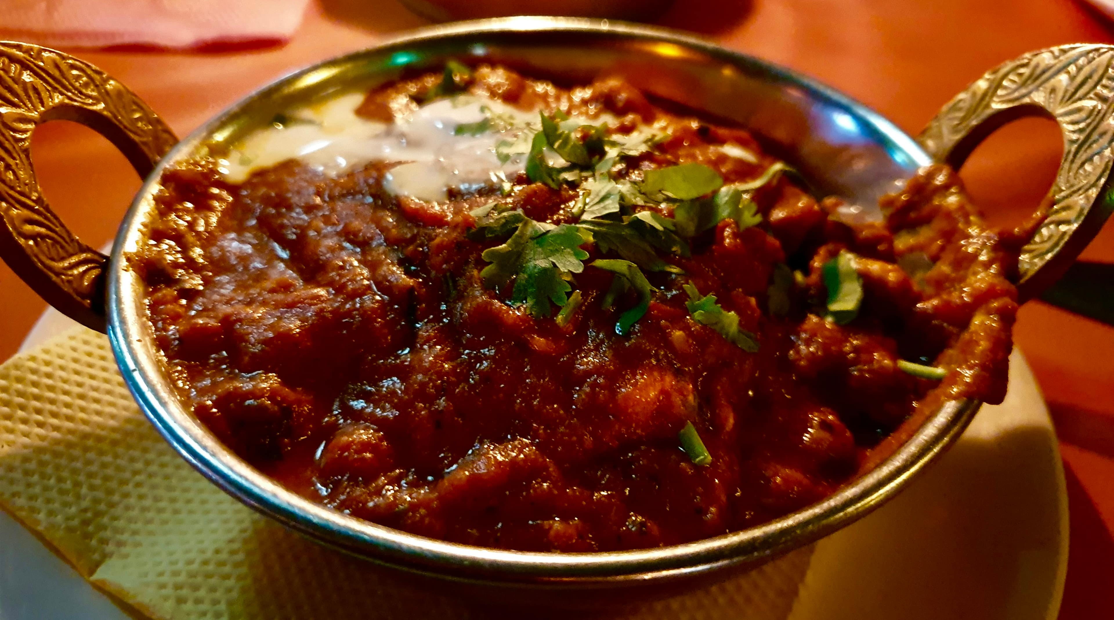 Lamb karahi with rich masala and fresh garnish