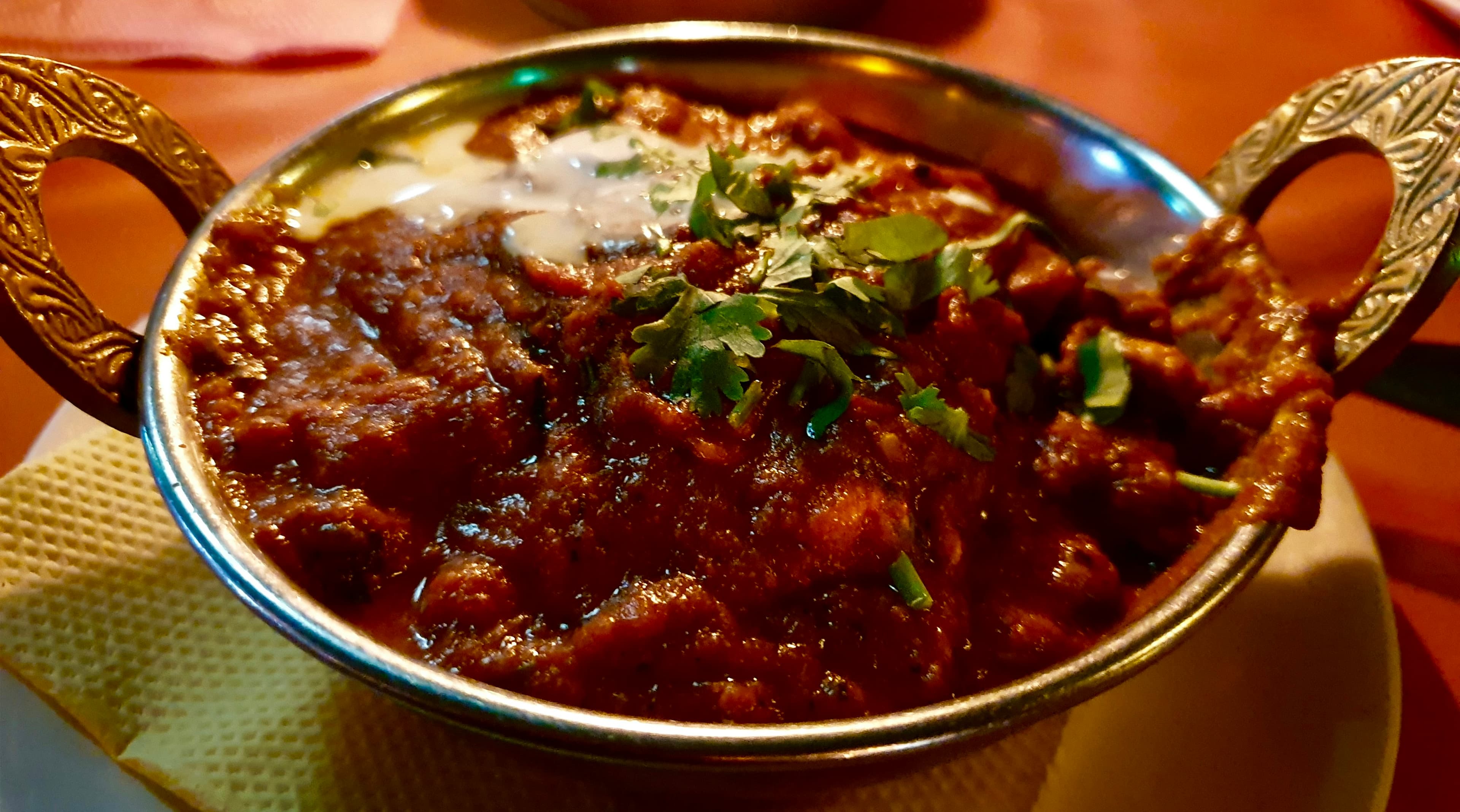 Lamb karahi in a dark serving dish